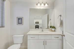 Half bath featuring vanity and toilet