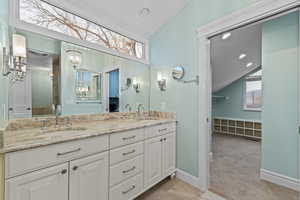 Full bathroom featuring double vanity, lofted ceiling, light carpet, and recessed lighting