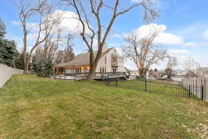Fenced backyard with a deck