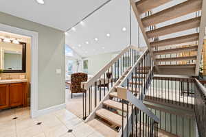 Stairway with carpet floors, tile patterned floors, and recessed lighting