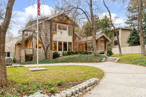 View of front of property featuring stone siding and stucco siding