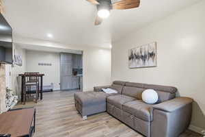 Living area featuring light wood-type flooring, ceiling fan, and recessed lighting