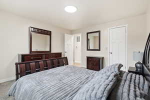 Bedroom with light carpet and baseboards
