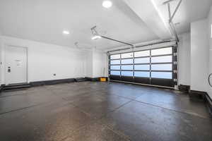 Garage with baseboards and recessed lighting