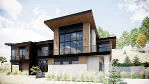 Rear view of house featuring stone siding and a balcony