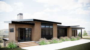 Back of house featuring a chimney