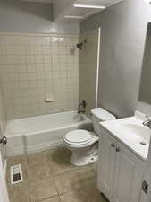Full bath featuring vanity, shower / bathtub combination, and light tile patterned flooring