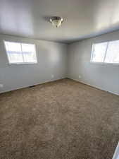Empty room with carpet and plenty of natural light