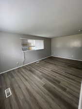 Spare room with wood finished floors and baseboards