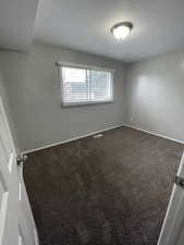 Empty room featuring carpet floors and baseboards