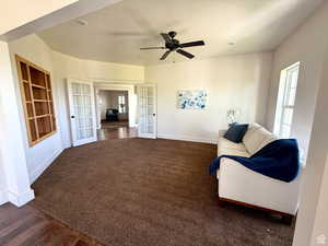 Sitting room with french doors, built in shelves, dark carpet, a ceiling fan, and recessed lighting