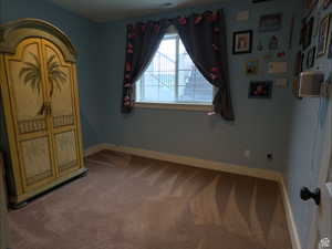 Unfurnished bedroom featuring baseboards and carpet flooring