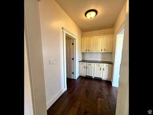Hallway with dark wood finished floors and a textured ceiling