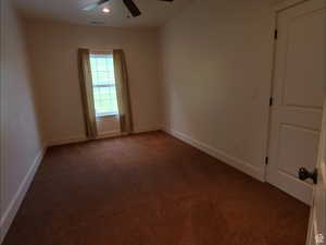Unfurnished room featuring dark colored carpet, ceiling fan, and recessed lighting