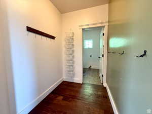 Hall featuring baseboards and dark wood-style flooring
