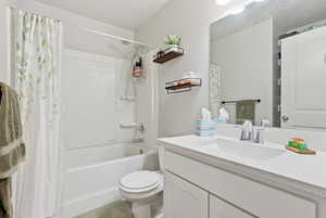 Full bath featuring vanity and shower / bath combo with shower curtain