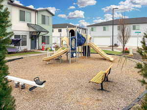 Private tot-lot with slides, climbing wall and park benches.