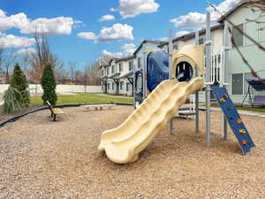 Private tot-lot with slides, climbing wall and park benches.