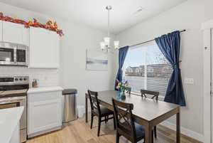 The dining space is open to the rest of the home, and offers a large picture window to the exterior.