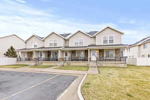 Large front porch, cultured stone and siding exterior.