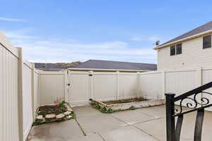 Enclosed backyard with gate to garage.