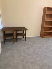 Dining space featuring light colored carpet and baseboards