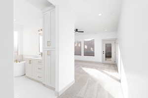 Hall featuring light colored carpet and recessed lighting