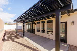 Fenced backyard with a pergola and a patio area