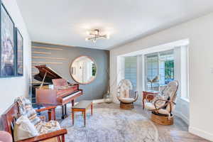Sitting room featuring healthy amount of natural light and a chandelier