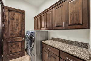 Laundry room featuring cabinet space and washer and dryer