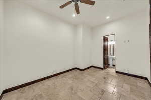 Unfurnished room featuring stone tile floors, ceiling fan, and recessed lighting