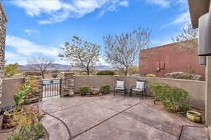 View of patio / terrace with a gate and a mountain view