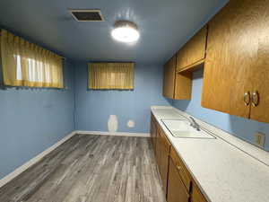Kitchen featuring brown cabinetry and light wood-style flooring