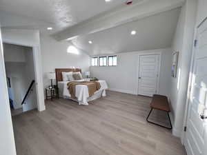 Bedroom featuring a textured ceiling, light wood-style flooring, and recessed lighting