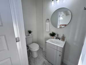 Bathroom featuring vanity and light marble finish floors