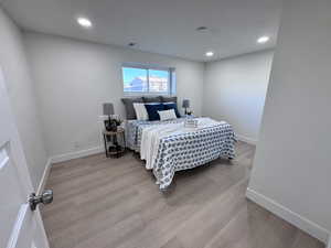 Bedroom featuring light wood-style floors and recessed lighting