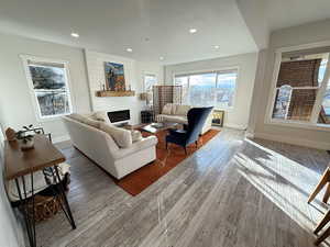 Living room featuring a fireplace, recessed lighting, and wood finished floors