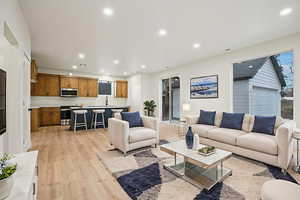 Living area featuring light wood-style floors and recessed lighting
