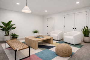 Living area with carpet flooring and recessed lighting