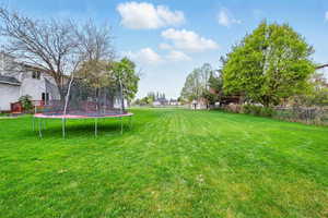 View of yard featuring a trampoline