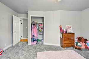 Bedroom featuring a closet, carpet floors, and ceiling fan