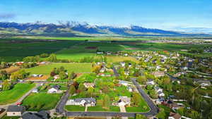 Aerial view of sparsely populated area featuring a mountainous background and nearby suburban area