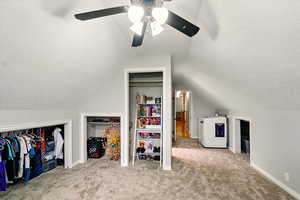 Bedroom with carpet, a textured ceiling, lofted ceiling, and ceiling fan