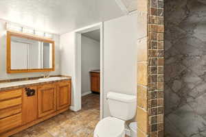 Bathroom with vanity and a textured ceiling