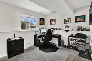 Office space with light colored carpet and baseboards