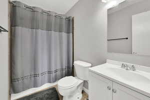 Full bathroom with a shower with shower curtain and vanity