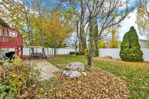 Fenced backyard with a deck