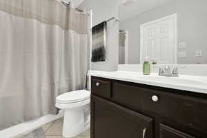Bathroom with vanity and light tile patterned flooring