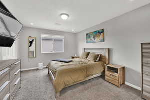Bedroom featuring light carpet and recessed lighting