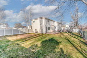 Rear view of property featuring a fenced backyard and a wooden deck